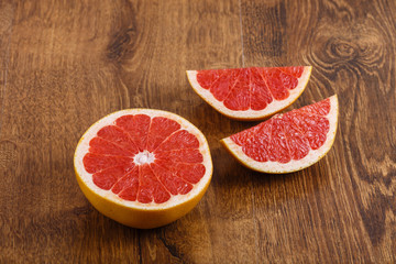 Fototapeta na wymiar pieces of grapefruit on the wooden table