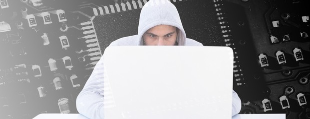 Composite image of serious burglar hacking into laptop