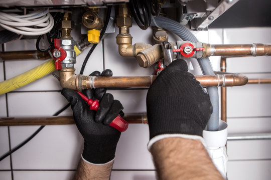plumber fixing central heating system

