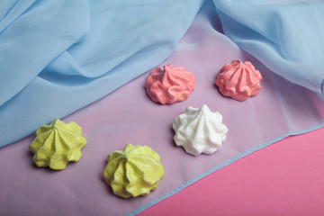 Fresh crispy meringues with love on a pink background.