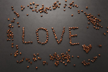 Top view of letter love, word made from coffee beans on black background for design. Saint Valentine's Day card on fabruary 14, holiday concept. Copy space for advertisement.