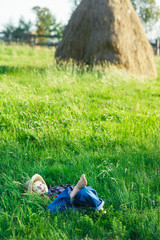 Handsome little boy relax on grass