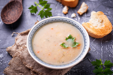 Healthy vegetarian peas soup on concrete background
