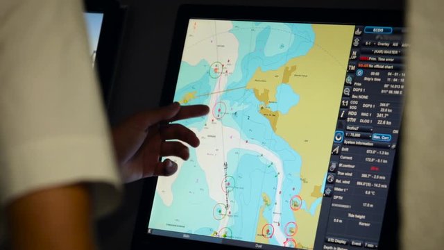 Naval school student using touch screen on simulation program to practice navigation
