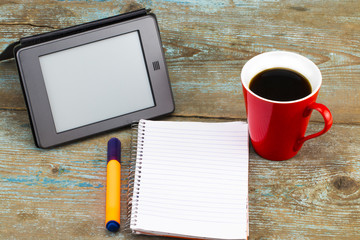 Digital Tablet Computer with Blank White Screen as Copy Space and a cup of coffee on wooden background