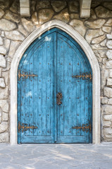 Fototapeta na wymiar Turquoise entrance door in the medieval style