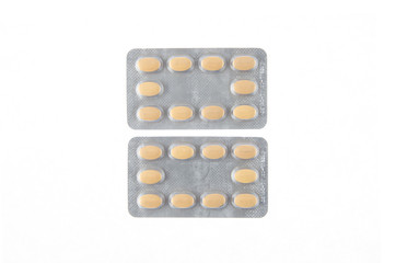two plates of yellow tablets on white isolated background
