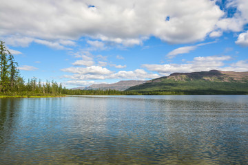 Fototapeta na wymiar The shore of a mountain lake on Putorana Plateau.