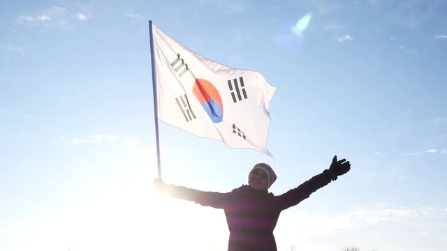 A woman waving the flag of South Korea