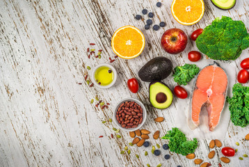 Selection of fresh fruit and vegetables, salmon, beans, and nuts. Concept of cooking and eating healthy food, fitness, dieting, vegetarian, and lifestyle. Ingredients good for heart and diabetes.