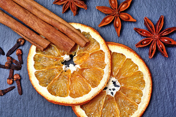 Dried orange fruit with spices on slate
