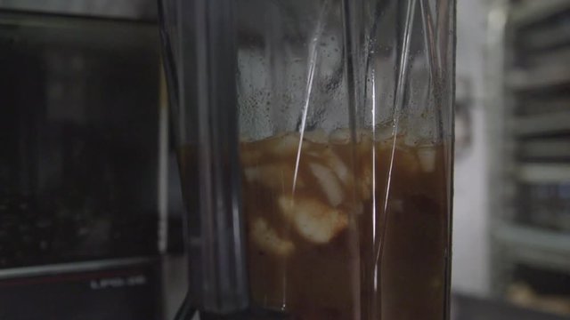 Close up, blender prepares mojo sauce