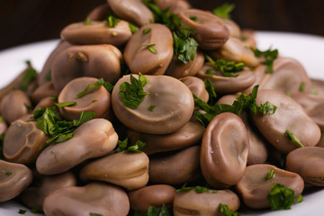 boiled broad beans on a rustic background