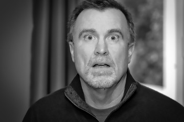 Black and white frightened adult male portrait