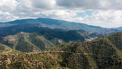 Fototapeta na wymiar Mountain landscape with road on the hillside of Troodos mountains, Cyprus.