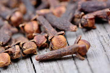 Heap of cloves on rustic wooden table