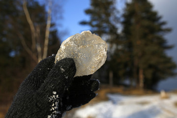 hand in glove keep ice cube, mountain scenery in the background