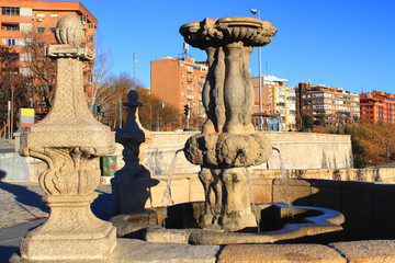 Ancient fountain on The Bridge of Toledo (Puente de Toledo), a baroque style bridge in Madrid, Spain
