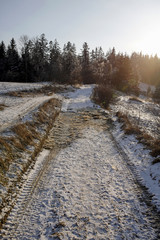 winter mountain landscape with road and sunlight flares