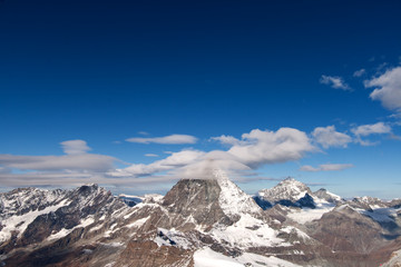 Winter panorama of mount Matterhorn covered with clouds, Canton of Valais, Alps, Switzerland 