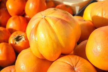 Grapefruit and persimmons on a street market stall