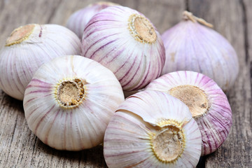 Heap of fresh garlic on wooden table