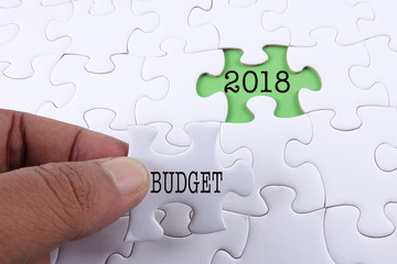 Business concept: Missing jigsaw puzzle with word BUDGET 2018.
