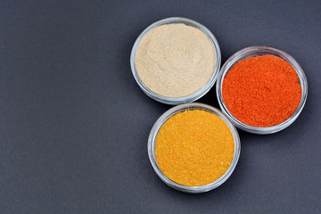 Spices in a bowls on black background