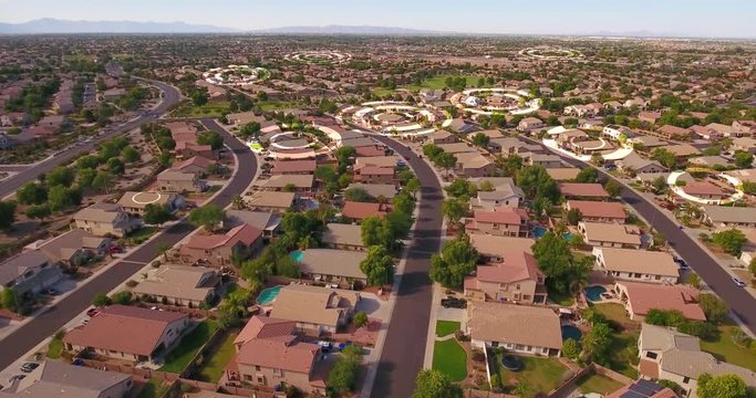 An aerial establishing shot of a typical Arizona residential neighborhood with WiFi hotspot markers over random homes. Phoenix suburbs.  	