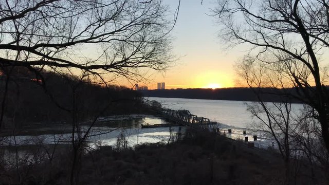 Winter Sunset on Hudson River and harlem river intersect  with George Washington Bridge in the distance