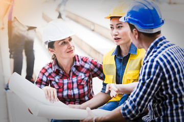 Engineers man and woman working on plan building construction in city