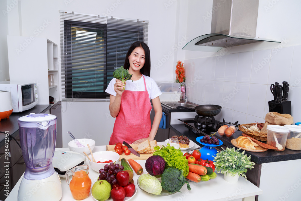 Sticker woman holding green fresh broccoli in kitchen room