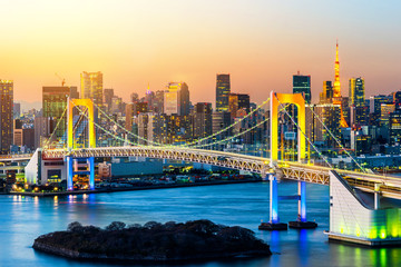 Asia Business concept for real estate and corporate construction - panoramic modern city skyline bird eye aerial view of Odaiba, tokyo tower & rainbow bridge under golden sun in Tokyo, Japan