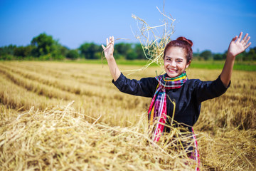 Naklejka na ściany i meble farmer woman relaxing with the straw in field