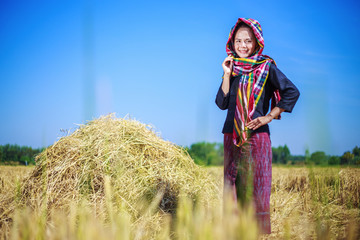 beautiful farmer woman with the straw in field