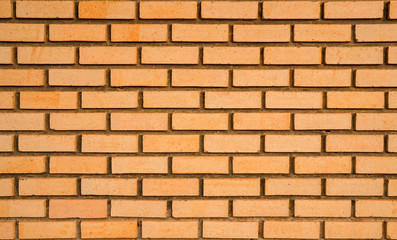 Orange brick wall texture background with space for text