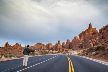 Hitchhiker on desert roadway