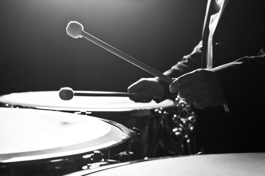  Hands musician playing the timpani closeup in black and white