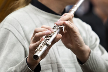 Detail of a musician flute in his hands closeup 