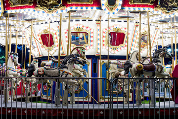 Fototapeta na wymiar Carousal Merry-go-round lit up at night 
