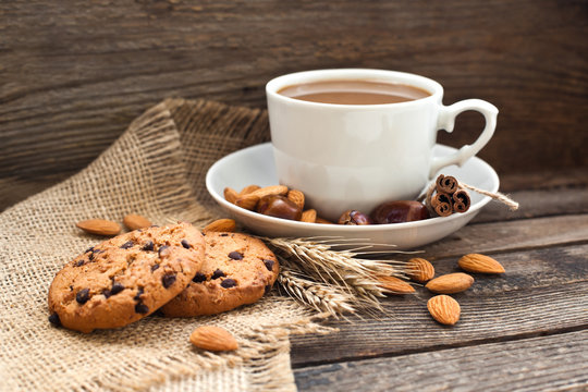 Coffee in a cup with cookies and nuts