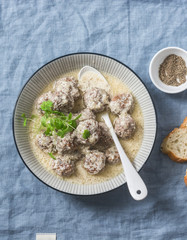 Lamb meatballs in a yogurt sauce - delicious healthy snack in a mediterranean style on a blue background, top view