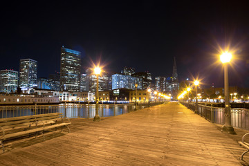 empty wood sidewalk near water in modern city