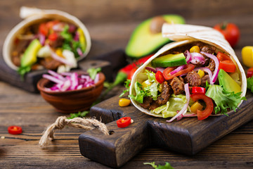 Mexican tacos with beef in tomato sauce and avocado salsa