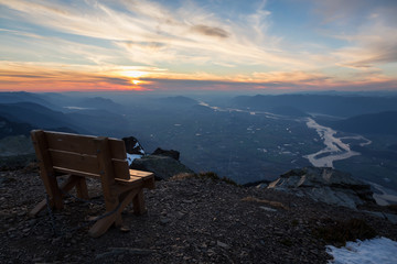 Wooden bench on top of a mountain peak overlooking the valley. Taken on top of Cheam near Chilliwack, East of Vancouver, BC, Canada.