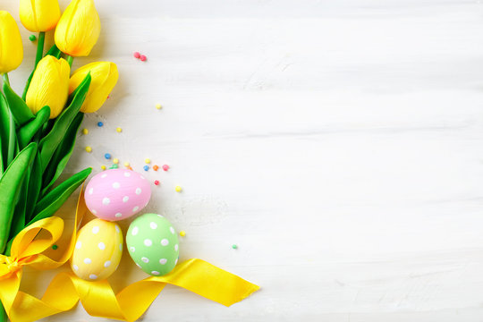 Happy Easter. Congratulatory easter background. Easter eggs and flowers.
