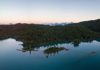 Fototapeta na wymiar Aerial landscape view of the beautiful glacier lake during a vibrant sunrise. Taken in Garibaldi, near Whistler and Squamish, North of Vancouver, BC, Canada.