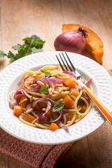 spaghetti with pumpkin onion and parsley, selective focus