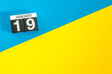January 19th. Day 19 of january month, calendar on blue and yellow background flat lay, top view. Winter time. Empty space for text