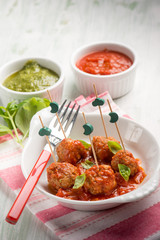 pesto meatballs with tomato sauce, selective focus